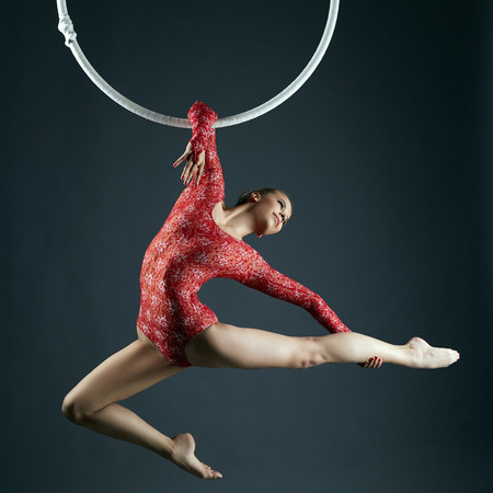 Studio shot of graceful female aerialist posing at cameraの写真素材