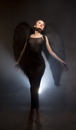 Mysticism. Studio shot of beautiful succubus with wingsの写真素材
