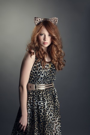 Shot of babe in leopard print dress and cat ears, on grey backdropの写真素材