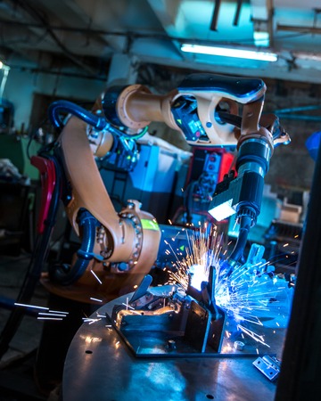 Manufacturing. Image of robotic machine welding metal fastenersの写真素材