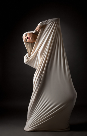 Fashion concept. Model posing in cocoon as butterfly transformedの写真素材