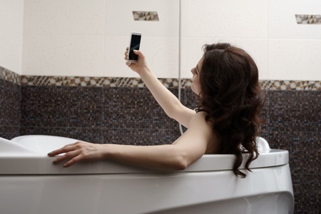Pretty woman doing her sexy photo while taking bathの写真素材