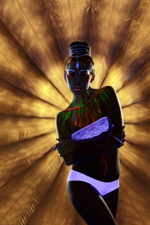 Clubbing. Seductive go-go dancer with glowing body artの写真素材