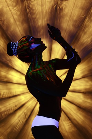 Clubbing. Sexy go-go dancer with luminous bodypaintingの写真素材