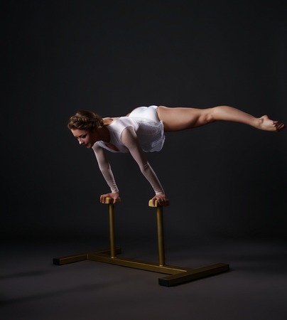 Beautiful female acrobat training on circus standsの写真素材