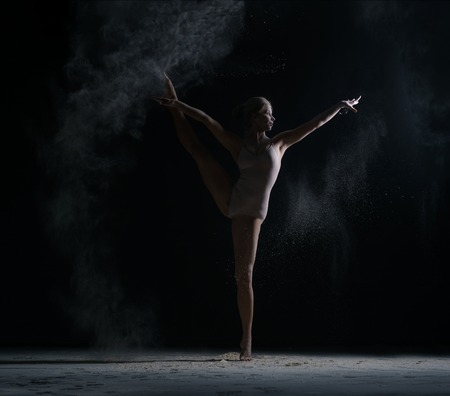 Modern art. Photo of flexible female dancer posing in studioの写真素材
