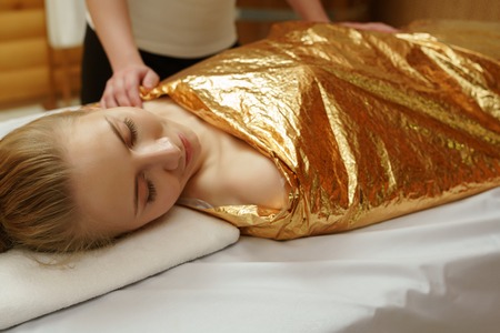 Caring about beauty and health. Body wraps in spa salonの写真素材