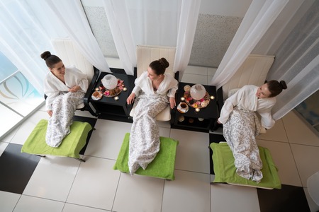 Top view of happy young women relaxing in beauty salonの写真素材