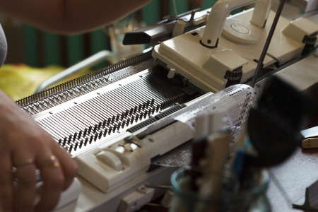 Modern machine for knitting on weaving mill, close-upの写真素材