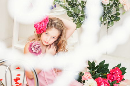 Beautiful elegant girl posing with flower in studio, close-upの写真素材