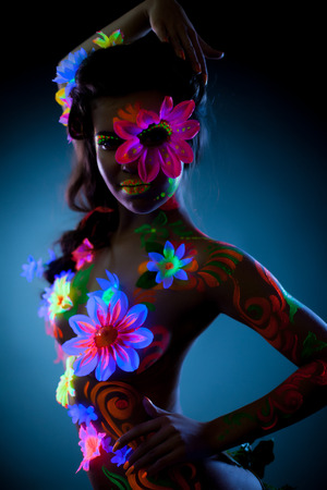 Portrait of cute mysterious woman with UV makeup, close-upの写真素材