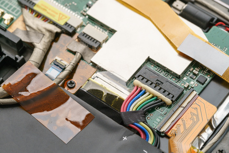 Close-up shot of opened electric device with wires, radio elements and microchipsの写真素材