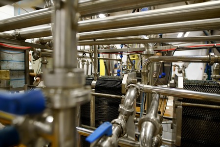 Automatic modern machinery at dairy production plant in operating position