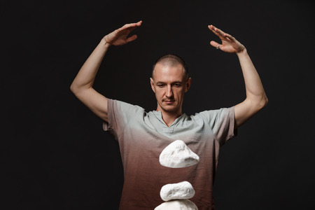 Telekinesis - man making stones levitatingの写真素材
