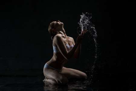 Sexy blonde in white lingerie in studio aquazoneの写真素材