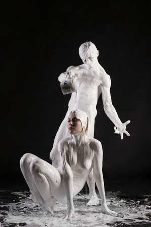 Naked couple covered by white body paint shotの写真素材