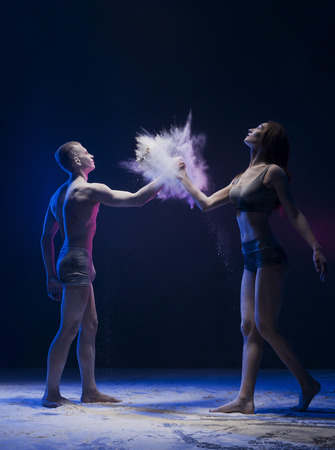 Young couple artistic shot with color dustの写真素材