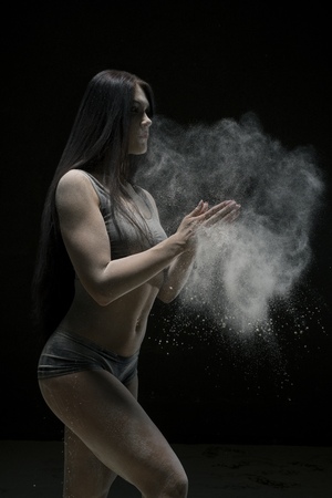 Beautiful sexy girl shot in white dust cloudの写真素材