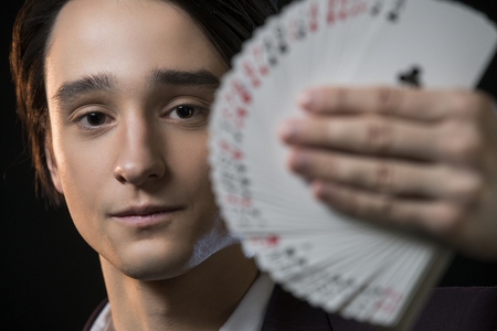 Young male showing tricks in the darkの写真素材