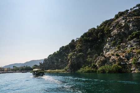 River trip along rocky green coast in Turkey viewの写真素材