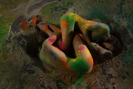 Two nude girls lying on the sand high angle shotの写真素材