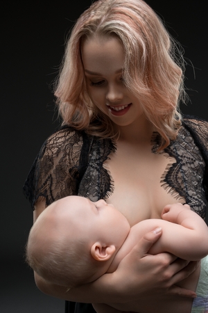 Pretty mother breastfeeding her baby viewの写真素材