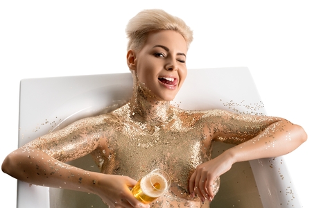 Happy blonde with shiny skin in bathの写真素材