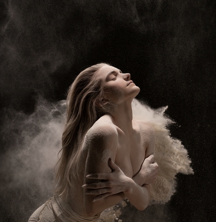 Sensual model covered with white powderの写真素材