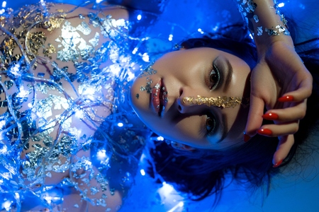 Nude girl with bodyart and garland portraitの写真素材