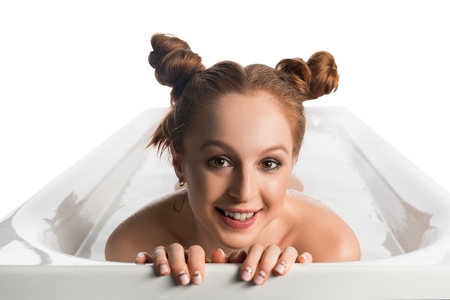 Pretty nude girl in foam bath isolated view