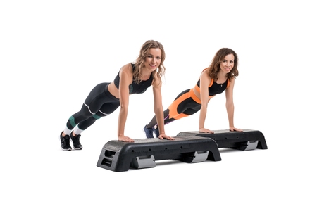 Girls doing fitness on step platform isolated shot