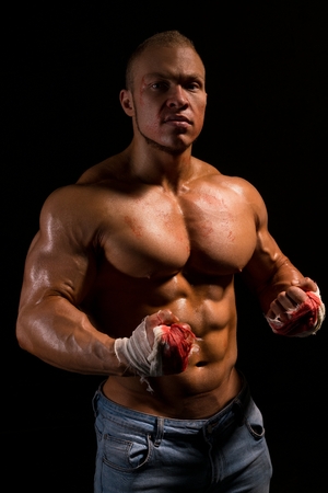 Shirtless muscular bodybuilder shot in the darkの写真素材