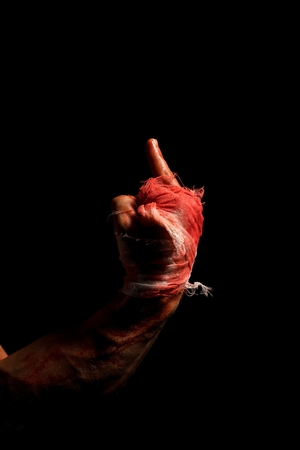 Male bloody hand in bandage view in the darkの写真素材