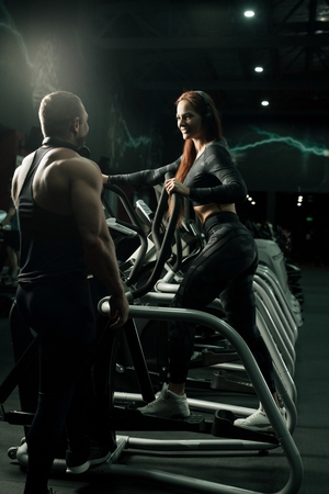 Sporty couple exercising on simulatorの写真素材