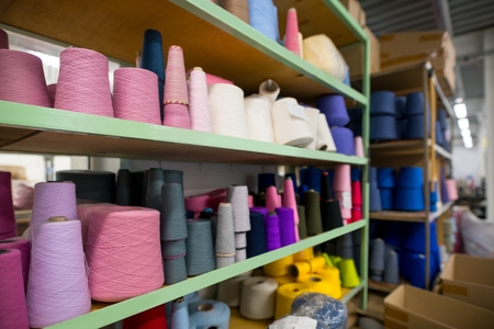 Sewing thread bobbins in manufactoring plantの写真素材