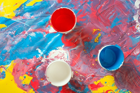 Buckets of bright paint on grungy surfaceの写真素材
