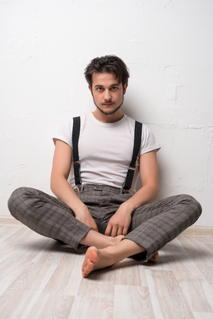 Handsome brunette against white wall shotの写真素材