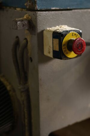 At sawmill. Stop button on machine, close-upの写真素材