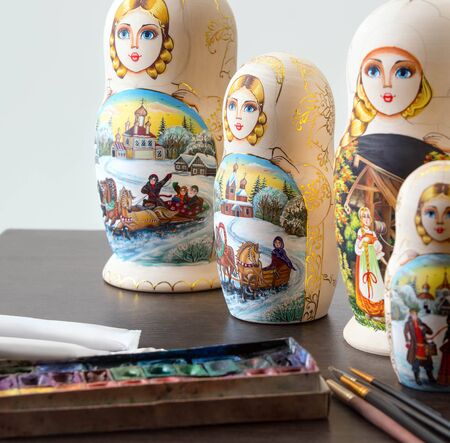 Wooden nested dolls on the table at workshopの写真素材