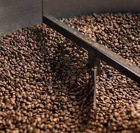 Coffee beans sifted and stirred in roasting machine