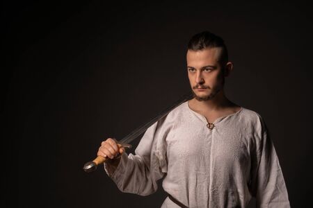 Young brunette in viking image portrait in the darkの写真素材