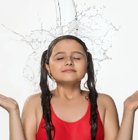 Teenage pretty girl catching water stream from topの写真素材
