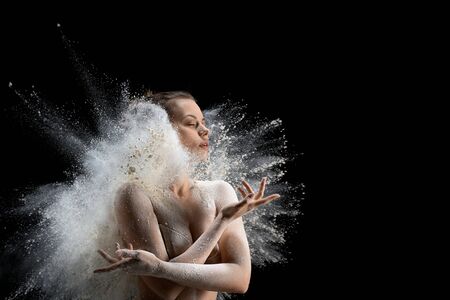 Sexy woman in underwear in white dust cloudの写真素材