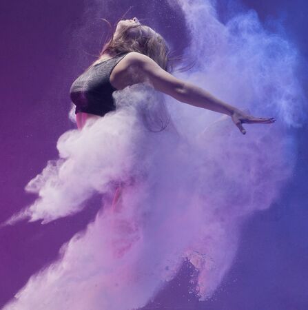 Girl in pointe shoe in dust cloud profile shotの写真素材