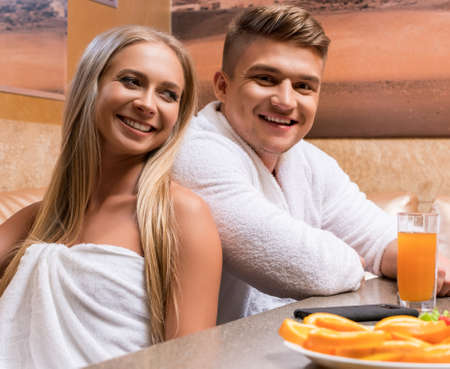 Nice young sexy couple shot at table in saunaの写真素材