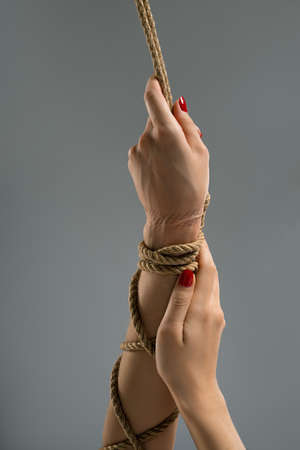Anonymous woman with tied hands during BDSM game