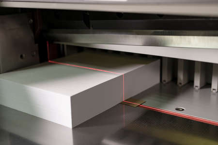 Modern machine for cutting sheets of paper close up view