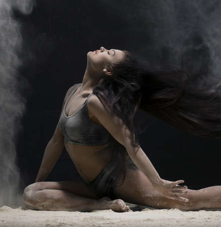 Brunette in a split view in a white dust cloudの写真素材