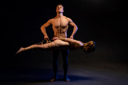 Man carrying woman with bondage during BDSM sessionの写真素材