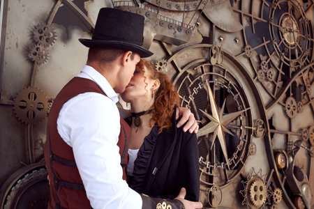 Young couple in styled clothes kissing and embracingの写真素材